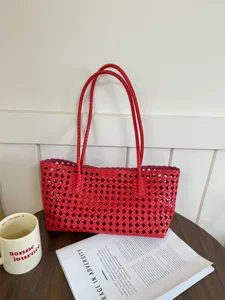 Red woven tote bag detail showing the intricate hollow mesh design, stylish summer handbag.