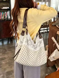 Detail shot of Korean style polka dot canvas shoulder bag with white lace and brown leather straps.