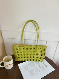 Green woven mesh tote bag detail shot, stylish hollow design for summer commuting and daily use.