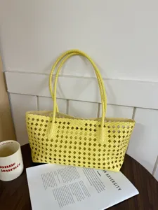 Yellow hollow woven tote bag, chic large capacity shoulder bag for daily summer commuting.