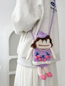 Handmade crochet cute doll crossbody bag detail view, featuring big mouth and cherry dress.