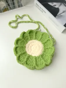 Handmade crochet green flower shoulder bag detail view, showing exquisite yarn knitting texture.