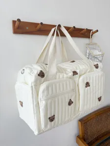 Large capacity quilted travel bag with cute brown bear embroidery for moms and daily use.