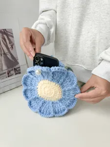 Detail view of handmade crochet flower shoulder bag, cute blue floral knit design for daily wear.