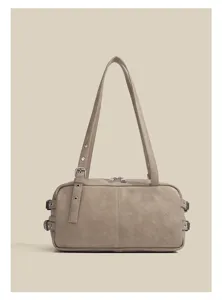 Retro motorcycle underarm shoulder bag detail showing side metal buckles and smooth zipper.