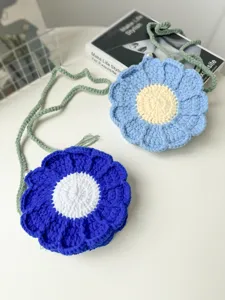 Handcrafted crochet flower bag detail view, blue yarn floral shoulder purse close-up.
