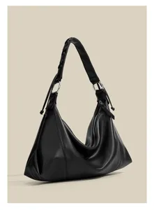 Detailed view of this elegant black slouchy shoulder bag with metallic ring and braided strap.
