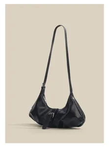 Detailed view of the black minimalist shoulder bag, featuring unique buckle and strap.