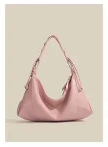 Pink shoulder bag detail shot, elegant hobo purse style with braided strap and metal rings.