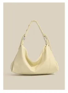 Detailed view of elegant pale yellow leather shoulder bag with chic woven handle design.
