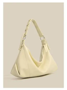 Detailed view of the elegant pale yellow hobo shoulder bag showing premium soft leather texture.