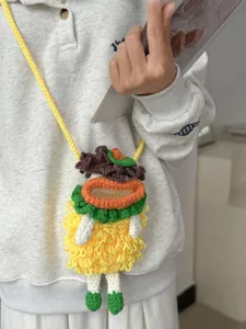 Detailed close-up shot of the handmade crochet phone bag featuring unique knit texture and design.