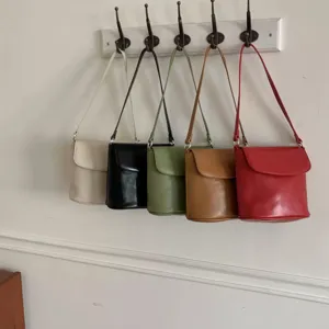Minimalist stylish leather bucket bag, versatile single shoulder crossbody for women.