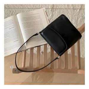 Niche design black leather crossbody bucket bag, versatile minimalist style single shoulder handbag.