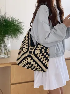 Stylish black and white crochet straw tote bag, perfect for summer beach and daily wear.