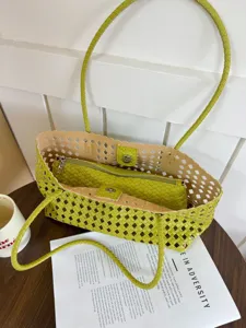 Detailed view of the green woven lattice tote bag with inner pouch, stylish hollow design.