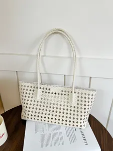 Detailed view of white woven hollow tote bag showcasing texture, summer commuting style.