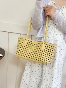 Detailed view of the yellow woven leather tote bag, perfect for summer commuting and style.