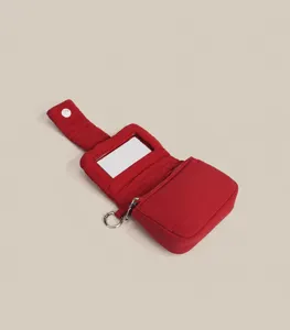 Red cosmetic bag detail showing interior mirror and structure design for lipstick and coins