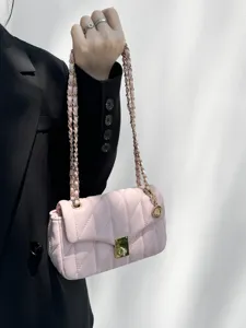 Detailed view of the pink quilted chain shoulder bag, showing gold hardware and soft leather.