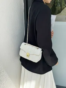 Elegant white quilted shoulder bag with gold chain strap and classic metal lock clasp for women.