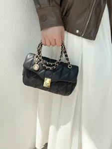 Black quilted chain shoulder bag for women, elegant fashion crossbody bag with gold hardware.