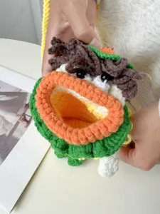 Handmade crochet phone bag featuring a cute cartoon monster design, soft knit texture.