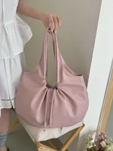 Detail shot of the pink pleated shoulder bag, featuring elegant slouchy design and drawstring.