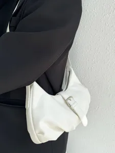 Minimalist white shoulder bag detail showing premium leather texture and stylish metal buckle.