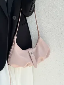 Minimalist pink shoulder dumpling bag detail, featuring sleek buckle and smooth zipper design.