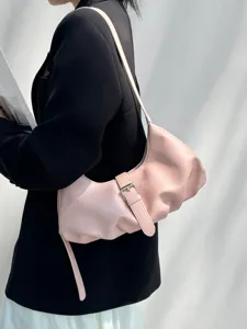 Minimalist pink shoulder dumpling bag for women, stylish crossbody purse for daily commute.