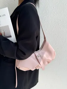 Detail shot of the minimalist pink ruched shoulder bag, showcasing premium leather.