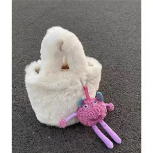 Fluffy plush bucket bag for women, cute winter shoulder bag with cute monster charm key chain.