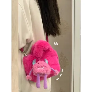 Pink plush shoulder bag with cute monster pendant, soft fluffy bucket bag for women stylish.