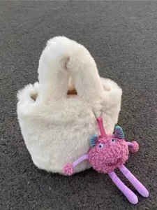 White fluffy plush bucket bag with cute pink monster charm, soft winter handbag for women.
