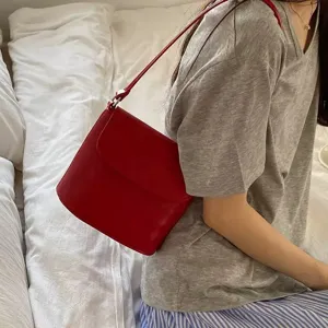 Minimalist red crossbody bucket bag, stylish niche design shoulder bag for modern women.