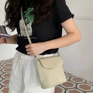 Minimalist leather crossbody bucket bag for women, chic trendy single shoulder handbag.