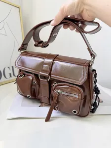 Brown patent leather motorcycle shoulder bag with multiple zipper pockets and metallic details.