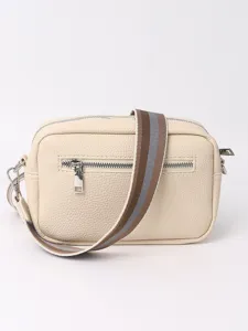 Detailed view of the beige PU leather crossbody bag with striped strap and front zipper pocket.