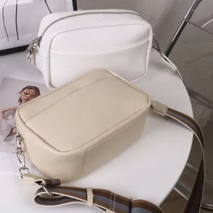 Casual minimalist solid color PU leather crossbody bag with wide strap, daily detail view.