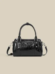 Black leather Boston shoulder bag, stylish casual bowling handbag with metal studs.