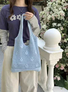 Light blue crochet knit tote bag detail, casual hollow shoulder bag design for summer daily wear.