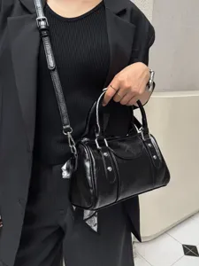 Black glossy Boston shoulder bag, stylish commuter bowling bag with strap and ribbon.