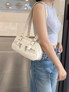 White retro boston shoulder bag detail, stylish metal grommet straps and front zip pockets.