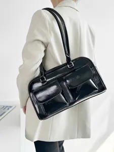 Black patent leather shoulder bag detail, retro college style tote with dual pockets.