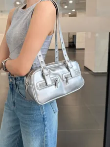 Stylish silver metallic shoulder bag, retro bowling style with dual front pockets and sleek design.