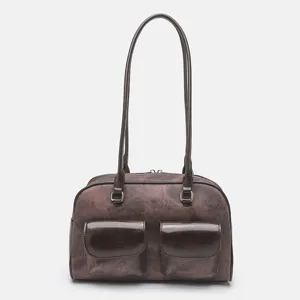 Brown vintage shoulder bag with dual front pockets and long handles for daily casual commute use.
