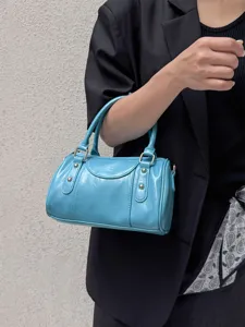 Stylish blue patent leather Boston shoulder bag, niche design handbag for women commuting daily.