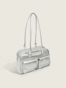 Detailed view of stylish silver metallic shoulder bag with double straps and front pockets