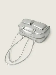 Silver metallic shoulder bag detail, vintage college style handbag with dual handles and pockets.